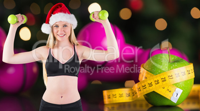 Composite image of festive fit blonde smiling at camera