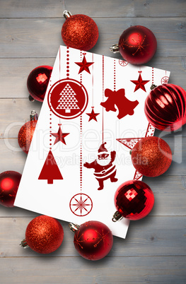 Composite image of hanging red christmas decorations