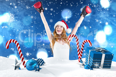 Composite image of festive redhead cheeering with boxing gloves