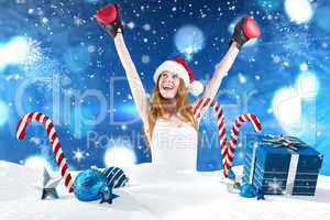 Composite image of festive redhead cheeering with boxing gloves