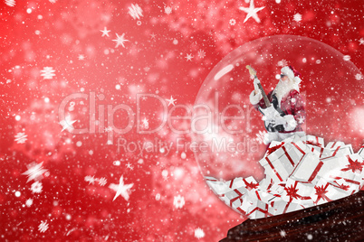 Composite image of santa rocking out in snow globe