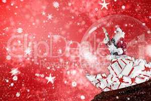 Composite image of santa rocking out in snow globe