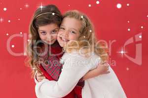 Composite image of festive little girls hugging and smiling