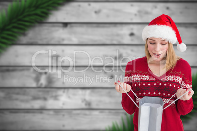 Composite image of woman looking in bag