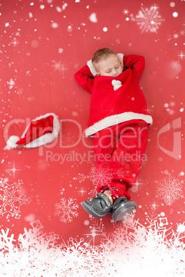 Composite image of little boy napping in santa costume