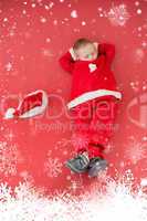 Composite image of little boy napping in santa costume