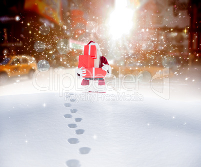 Composite image of santa carrying gifts in the snow