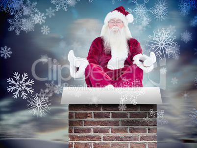 Composite image of santa claus sits and meditates