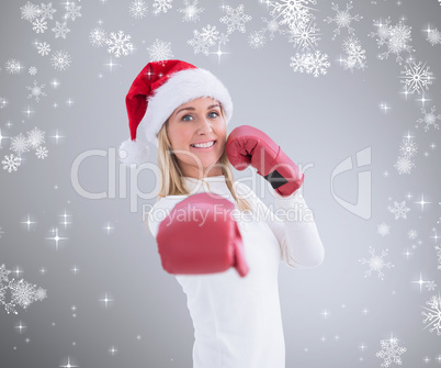 Composite image of festive blonde in boxing gloves