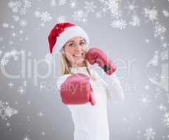 Composite image of festive blonde in boxing gloves