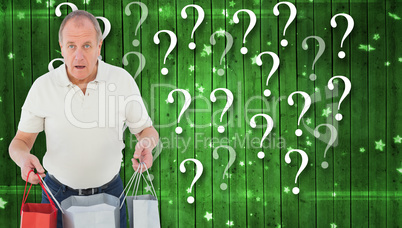 Composite image of shocked man holding shopping bags