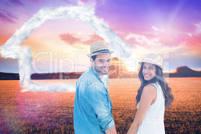 Composite image of happy hipster couple holding hands and smilin