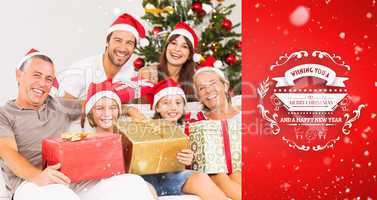 Composite image of happy family at christmas holding gifts