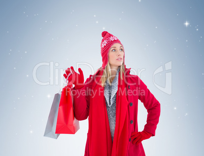 Blonde in winter clothes holding shopping bags