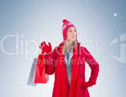 Blonde in winter clothes holding shopping bags