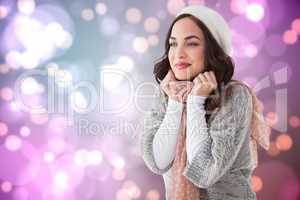 Composite image of portrait of a pretty brunette in winter cloth