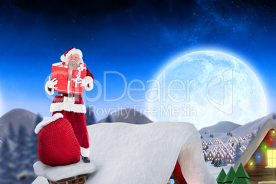 Composite image of santa on cottage roof