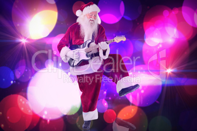 Composite image of santa claus has fun with a guitar