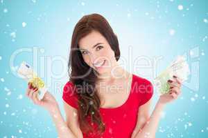 Composite image of cheerful brunette holding her cash money