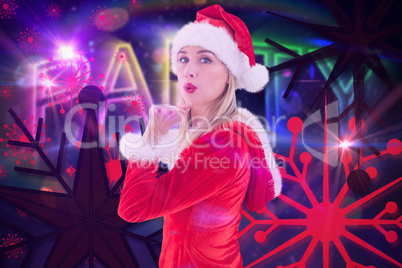 Composite image of festive blonde blowing a kiss
