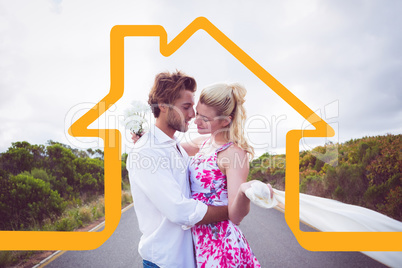 Composite image of cute couple standing on the road hugging