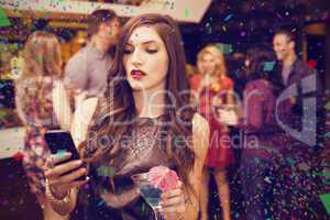 Composite image of pretty brunette sending a text