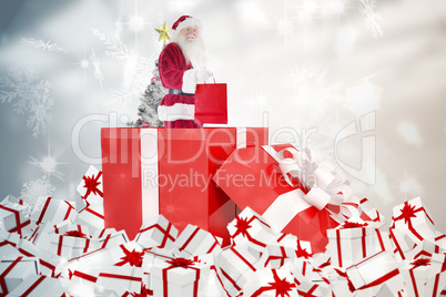 Composite image of santa standing in large gift