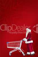 Composite image of santa pushes a shopping cart