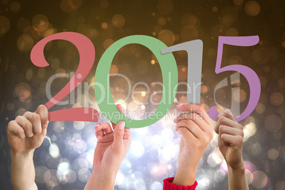 Composite image of hands holding poster