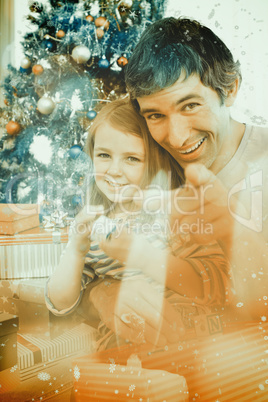 Composite image of father and little girl playing with christmas