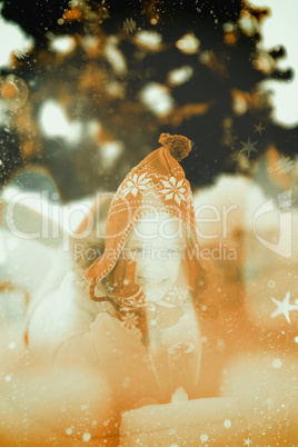 Composite image of festive little girl in hat and scarf