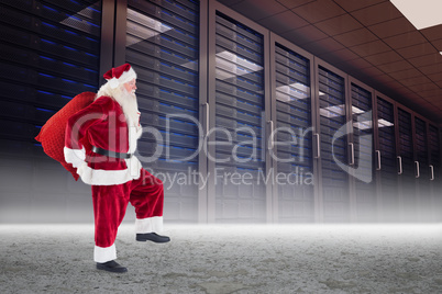 Composite image of santa carrying sack of gifts