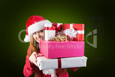 Composite image of festive redhead holding pile of gifts