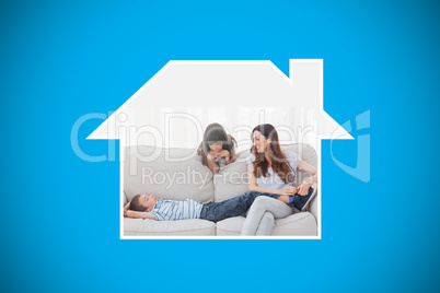 Composite image of mother sitting with her children on sofa