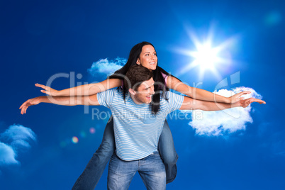 Composite image of young man giving girlfriend a piggyback ride