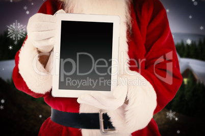 Composite image of santa claus showing tablet pc