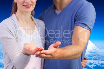 Composite image of couple holding out their hands