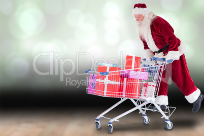 Composite image of santa rides on a shopping cart