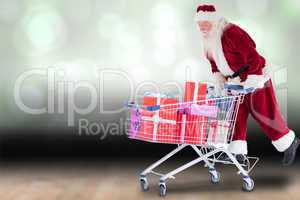 Composite image of santa rides on a shopping cart