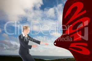 Composite image of focused blonde businesswoman pulling a rope