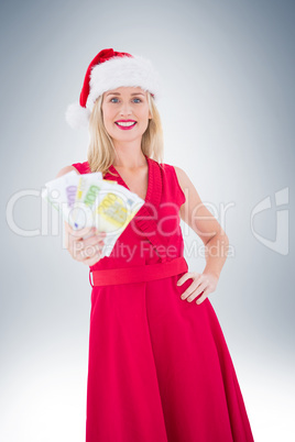 Festive blonde in red dress showing her cash