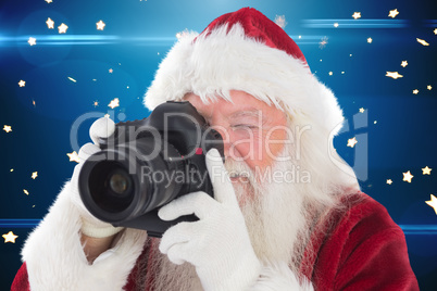 Composite image of santa is taking a picture