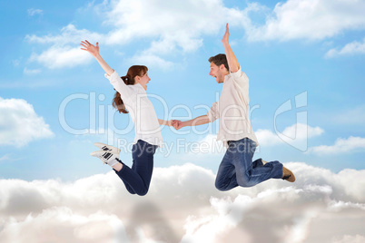 Composite image of couple jumping and holding hands