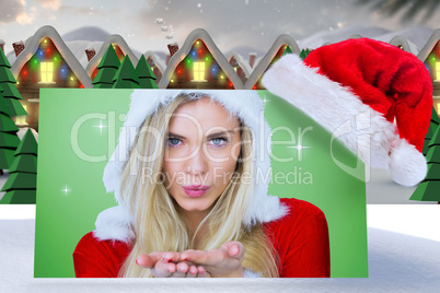 Composite image of pretty girl in santa outfit blowing