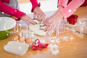 Composite image of festive mother and daughter making christmas