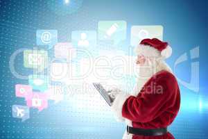 Composite image of santa uses a tablet pc