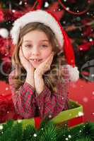 Composite image of festive little girl smiling at camera