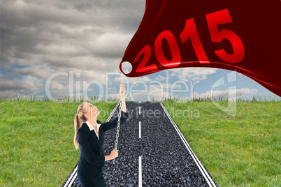 Composite image of businesswoman pulling a chain