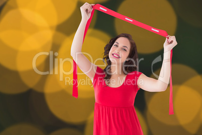 Composite image of stylish brunette in red dress holding scarf