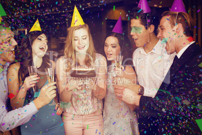 Composite image of attractive friends celebrating a birthday